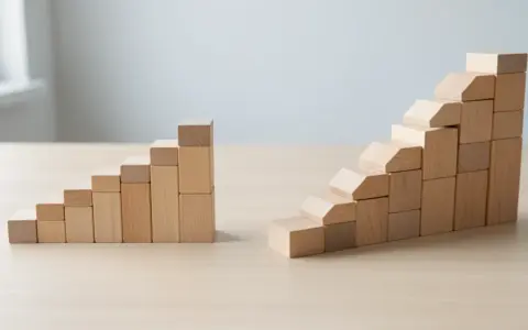 Two separate stair-like structures built from plain wooden blocks on a light wooden tabletop