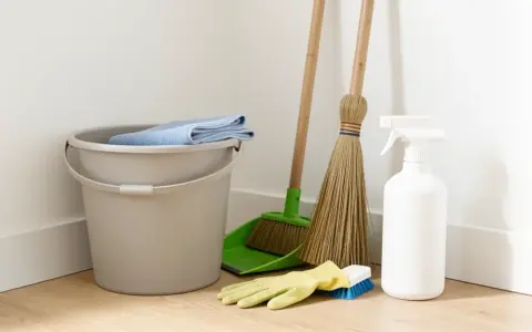 Plain cleaning tools arranged in a bright home utility corner without product labels